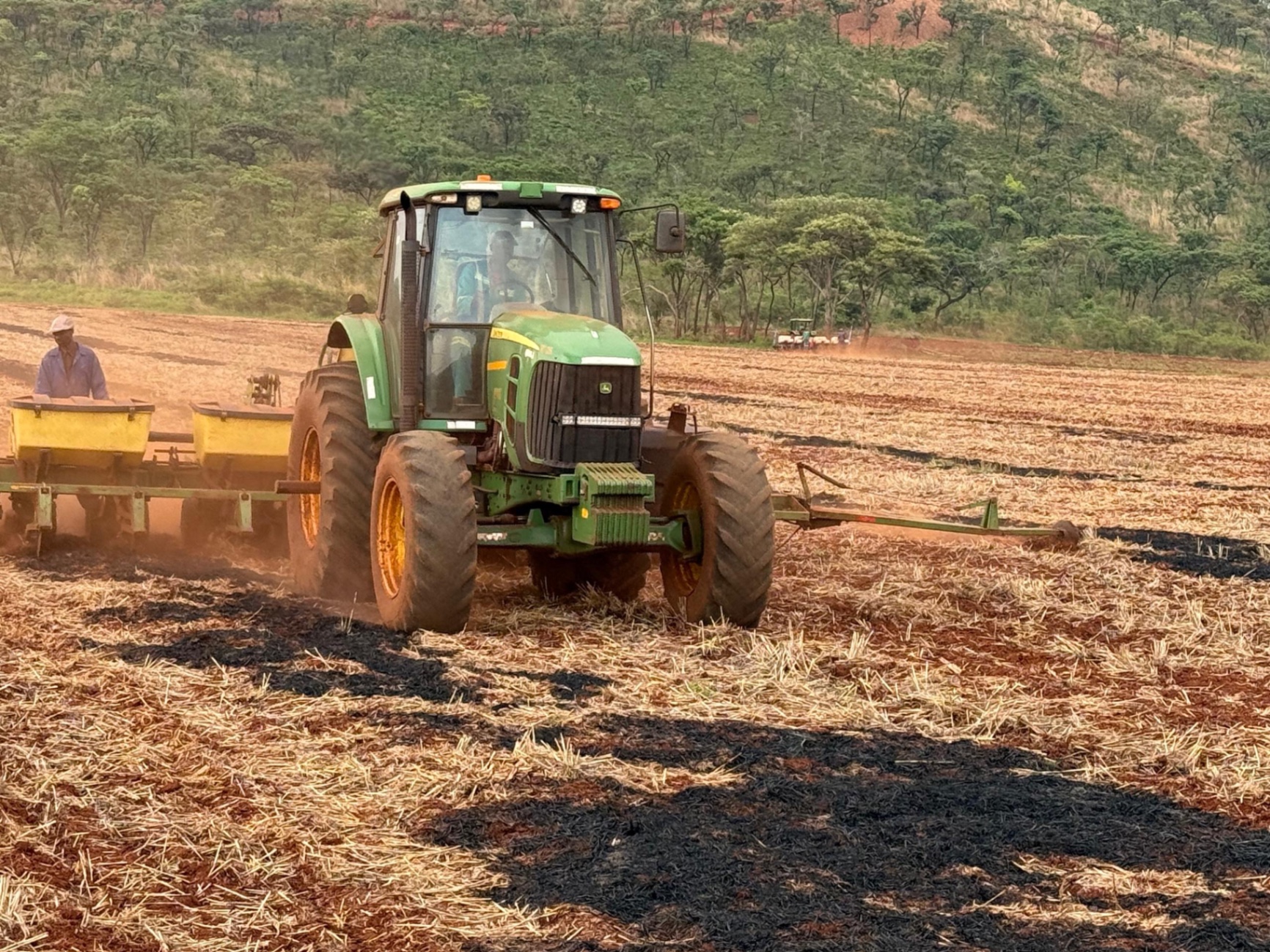 John Deere tractor planting into a prepared field