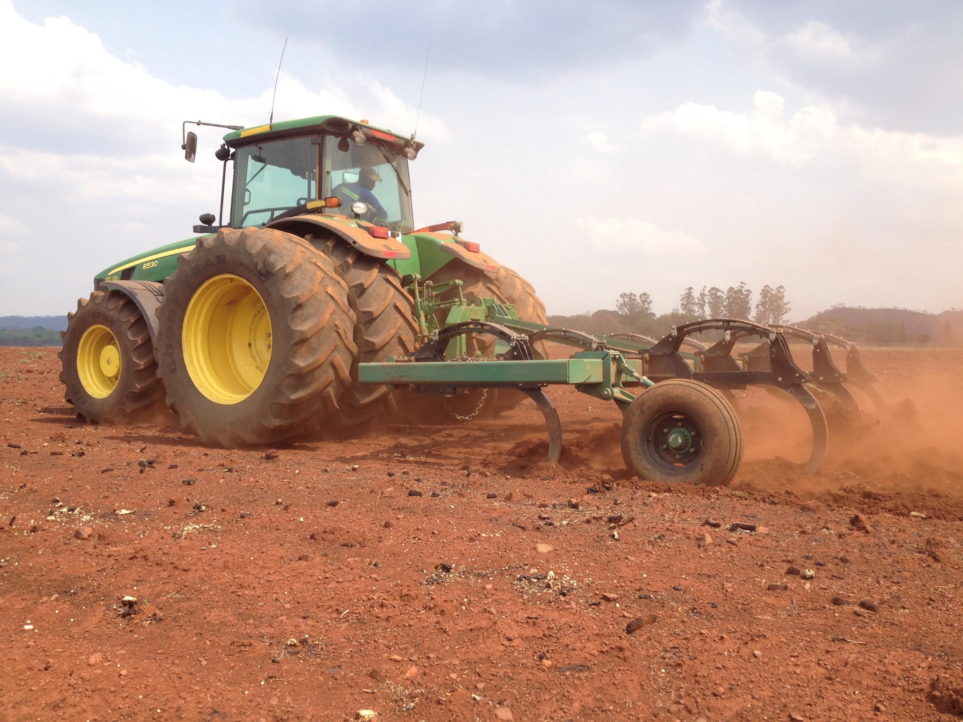 Riptill John Deere 8530 pulling a chisel plough through red Zimbabwean soil